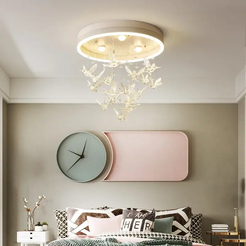 Modern crystal led chandelier with white frame, glowing led ring, and dangling crystal bird ornaments for bedroom ceiling light