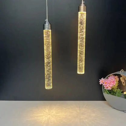 Two sleek cylindrical modern crystal led pendant lights with warm golden glow for dining room decorbites crystal led pendant