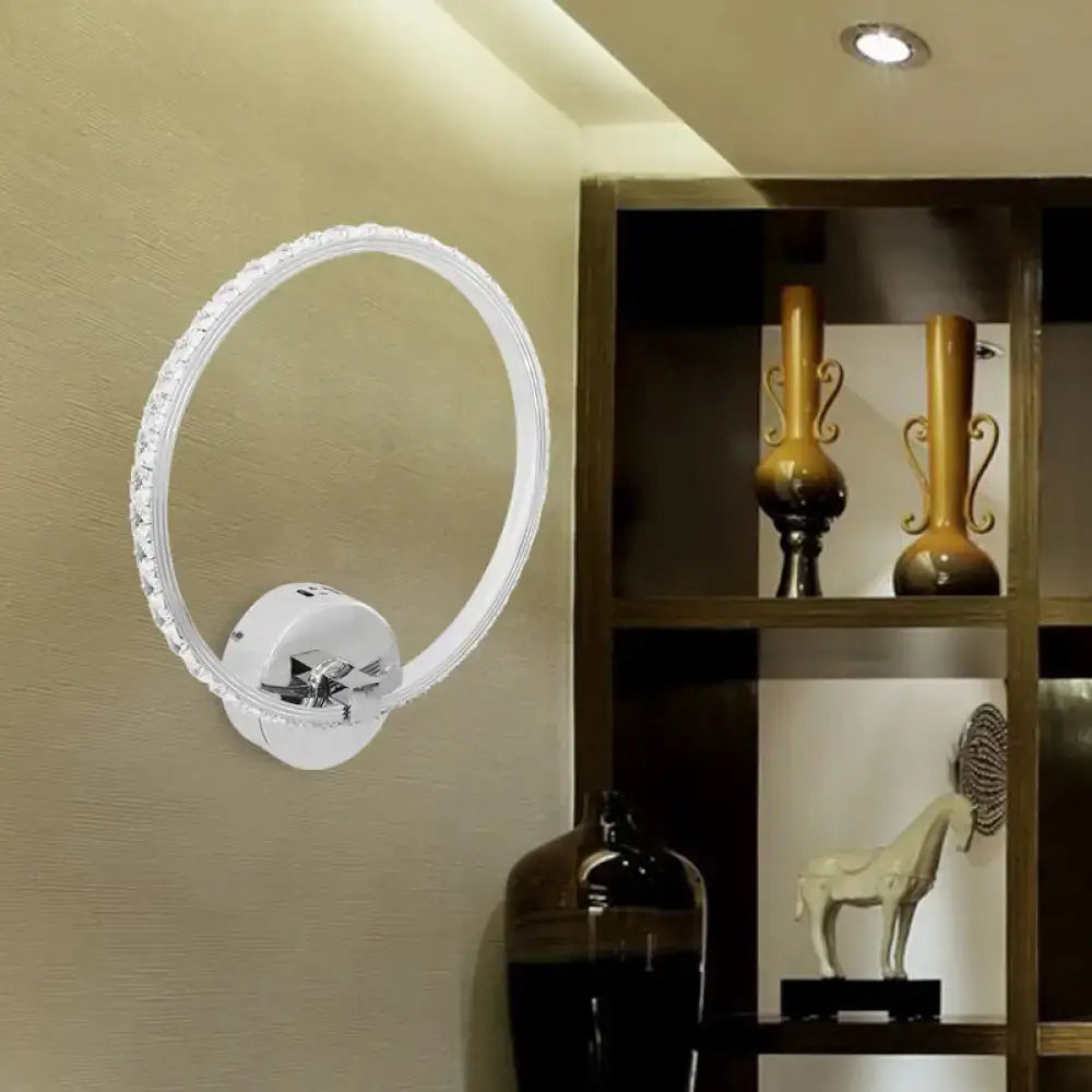 White circular modern crystal led wall sconce with chrome finish and embedded crystal ring for bedroom lighting