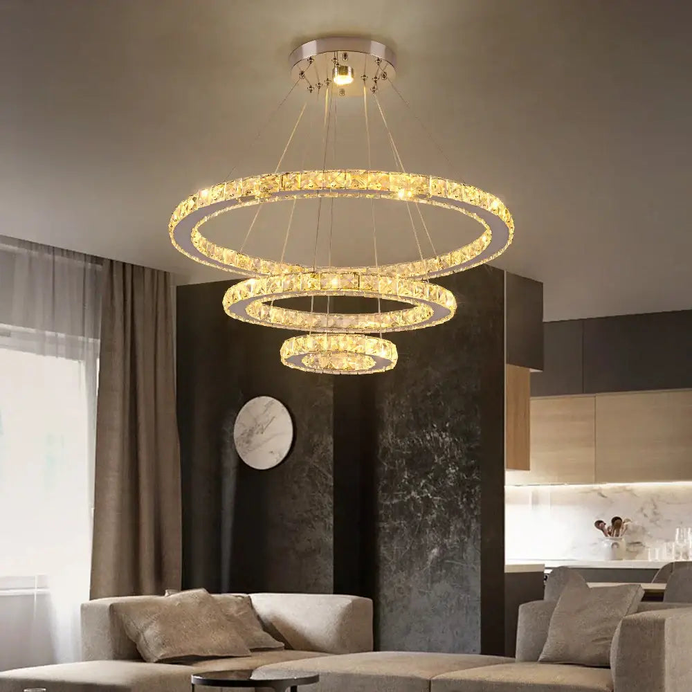 Modern three-tiered crystal rings led pendant light with sleek metallic finish and warm glow for dining room decorbites chandelier