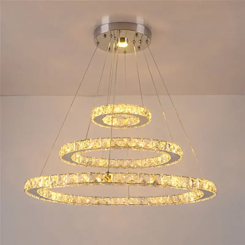 Modern crystal rings led pendant light with three-tiered faceted clear crystals in a silver-toned metal frame for dining room decorbites crystal rings