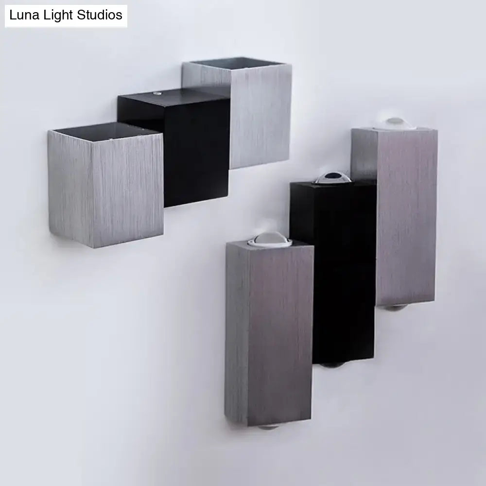 Modern cubic silver and black wall sconce with direct wired electric setup and sleek rectangular geometric design features maximum bulb wattage integration