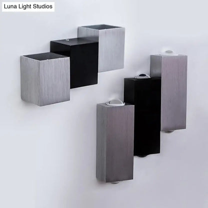 Modern cubic silver and black wall sconce with direct wired electric setup and sleek rectangular geometric design features maximum bulb wattage integration