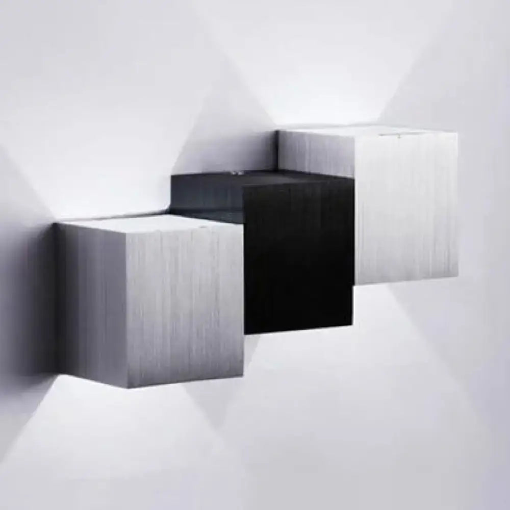 Modern cubic silver and black wall sconce with brushed metallic finish and black accents in a direct wired electric design
