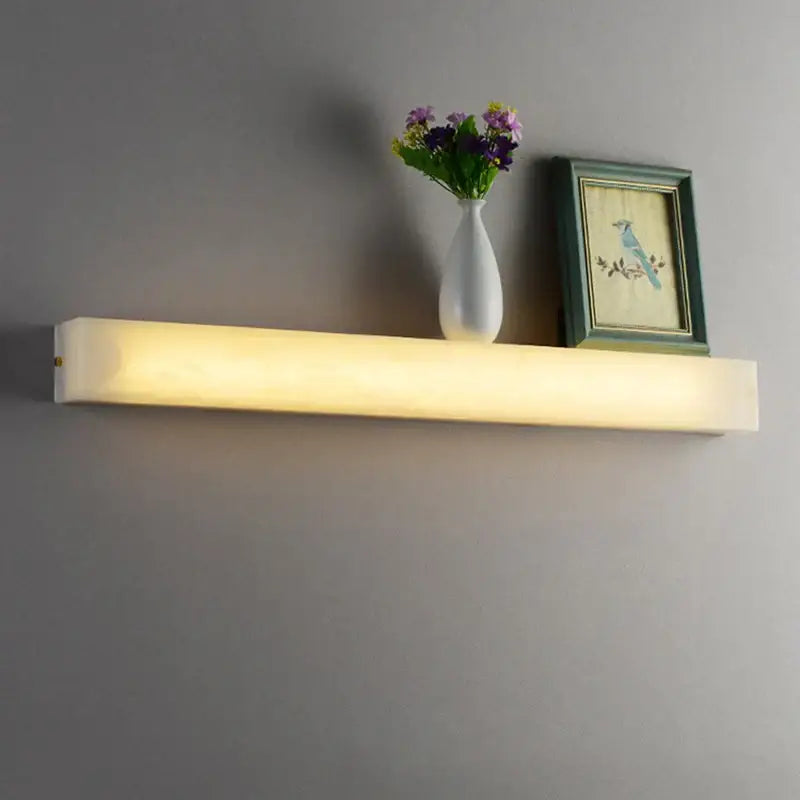 A sleek cuboid marble led wall lamp with frosted cover and warm yellow glow for bedroom decorbites wall lamp lighting
