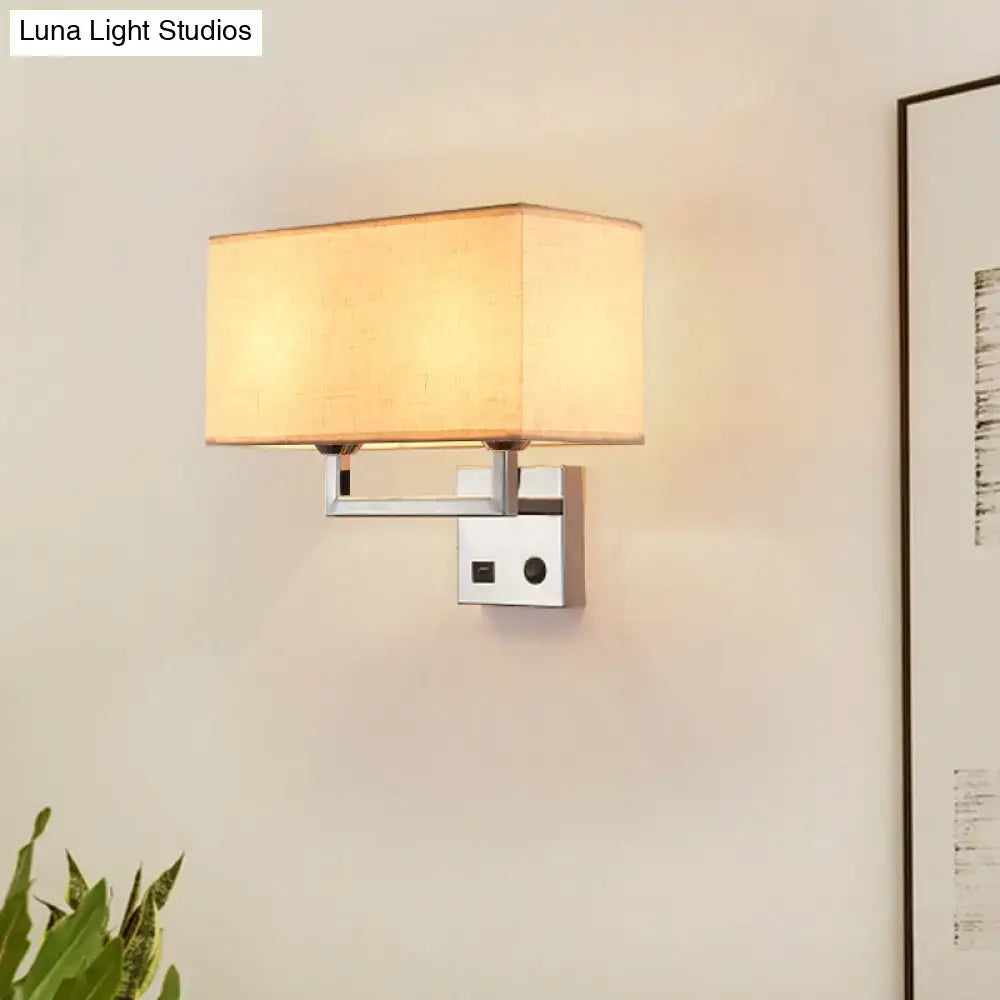 Modern cuboidal fabric wall light with beige white fabric shade and polished chrome frame for living room use
