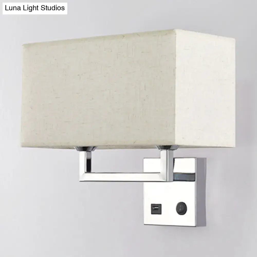 Modern cuboidal fabric wall light with beige white fabric shade and polished chrome finish featuring integrated usb port