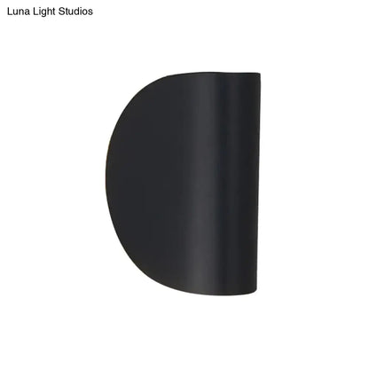 Black matte-finished semi-circular wall sconce light with modern curved design for bedroom ambient lighting
