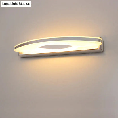 Modern curved led vanity sconce in chrome finish with silver curved led design and warm ambient bathroom lighting