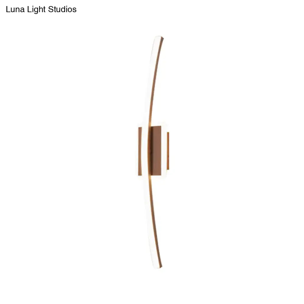Modern curved linear aluminum wall sconce with sleek curved arms and warm bronze finish for dining room lighting