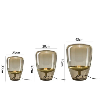 Three amber-tinted decorbites glass table lamps with gold metallic bases in sizes 23cm, 28cm, and 43cm for bedroom lighting