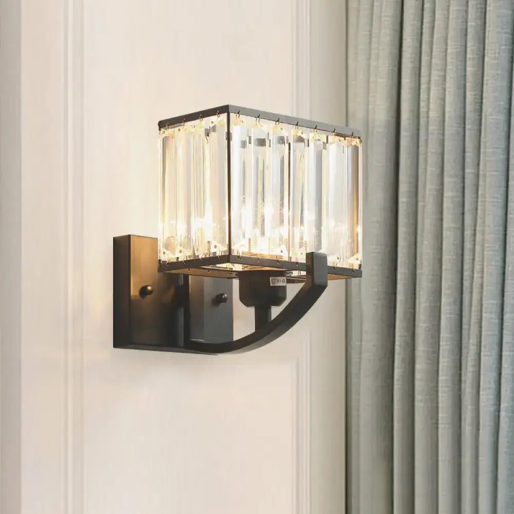 A modern dark bronze wall mount light with vertical crystal rods in a rectangular frame for bedroom use