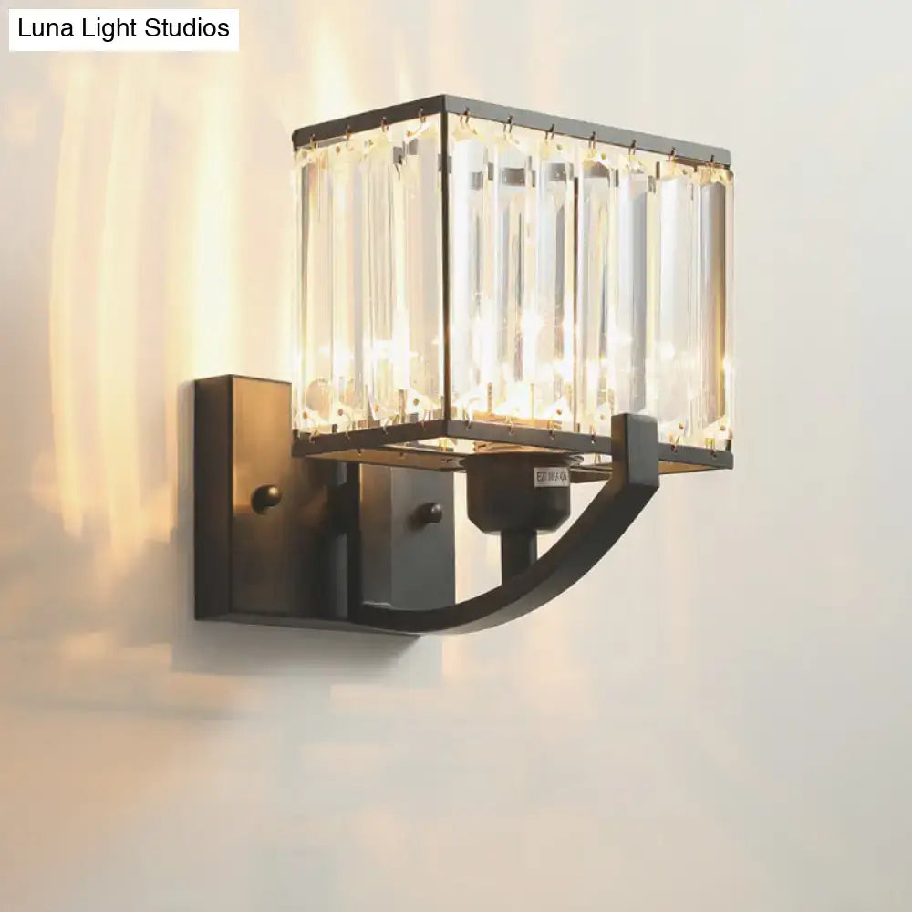 Modern dark bronze wall mount light featuring a rectangular frame with vertical crystal prisms in antique brass finish