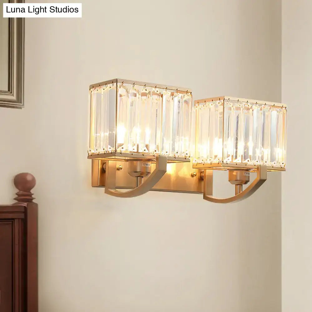Modern dark bronze and crystal wall mount light featuring gold-toned mount light with two rectangular crystal shades