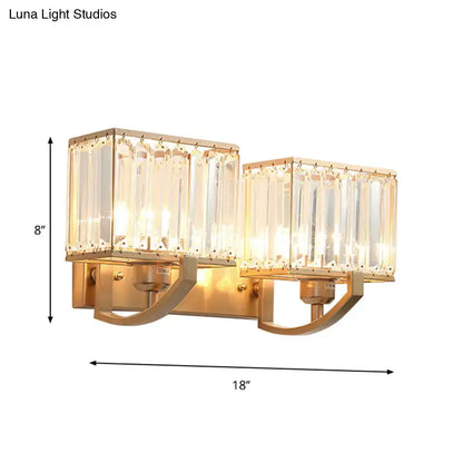 Gold-toned modern dark bronze and crystal wall mount light with two rectangular crystal glass shades for bedroom use