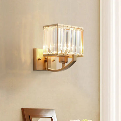 Gold-toned wall mount light with rectangular frame and vertical crystal rods for modern bedroom wall mount use