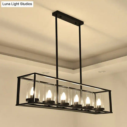 Black metal rectangular chandelier with five warm glowing bulbs and clear glass shade for classic black island lighting