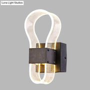 Modern dark bronze led wall lamp with translucent ribbed glass tubes emitting white warm light for bedroom use