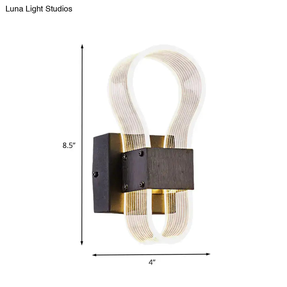 Modern dark bronze led wall lamp with sleek black metal base and ribbed glass arms emitting white warm light for bedroom