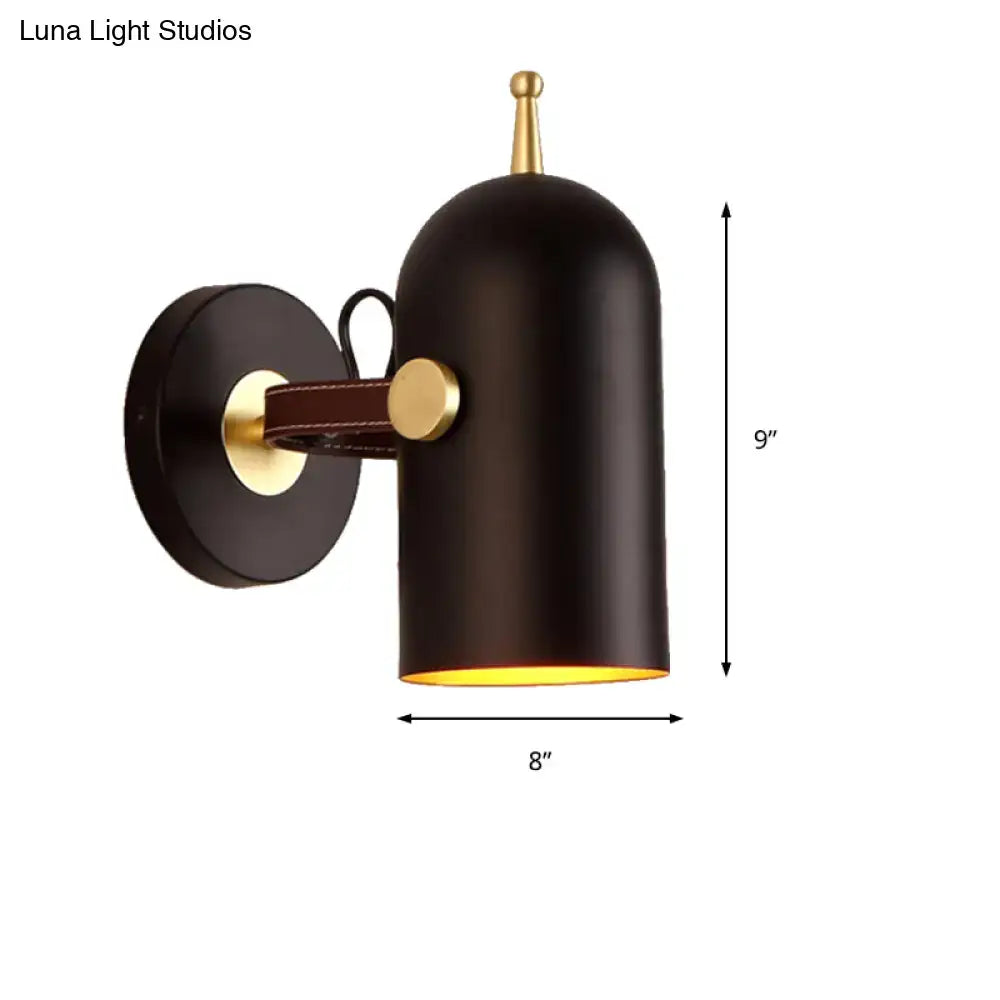 Modern wall lamp with black matte finish, brass accents, leather strap, and cup shade for office corridor lighting