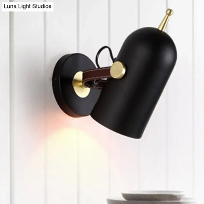 Modern wall lamp with black matte finish brass accents brown leather strap and cup shade for office corridor use