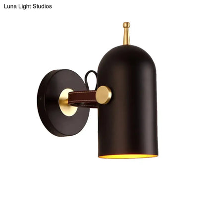 Modern wall lamp with black matte finish brass accents leather strap and cup shade ideal for office corridor lighting