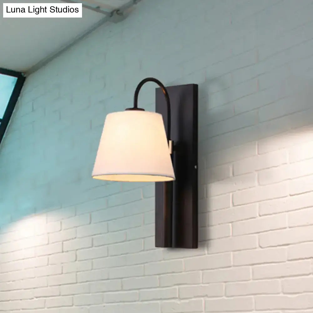 Modern black metal wall lamp with white fabric conical shade for living room use
