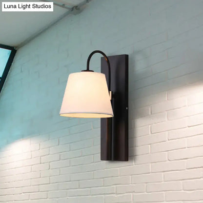 Modern black metal wall lamp with white fabric conical shade for living room use