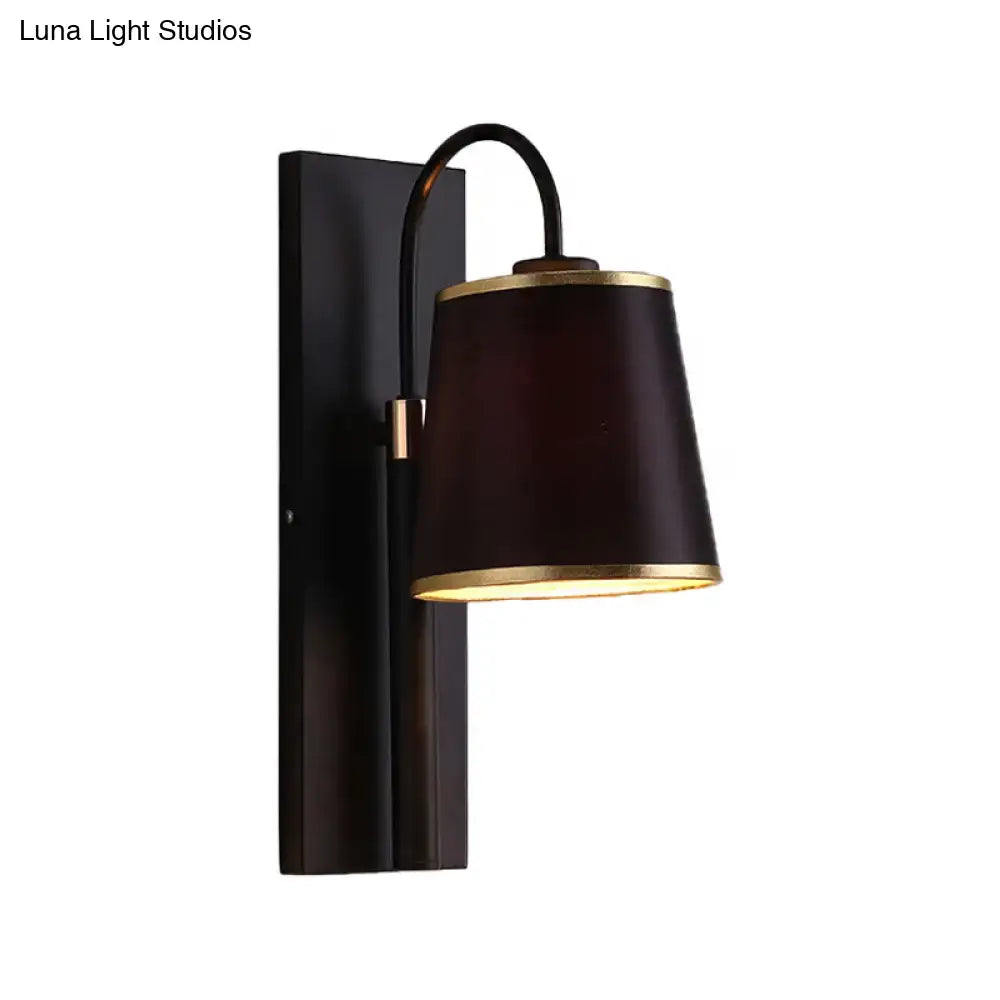 Modern dark brown fabric wall lamp with gold trim and conical shade mounted on black metal for living room sconce