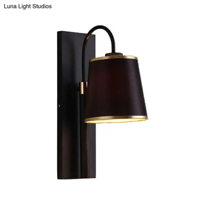 Modern dark brown fabric wall lamp with gold trim and conical shade mounted on black metal for living room sconce