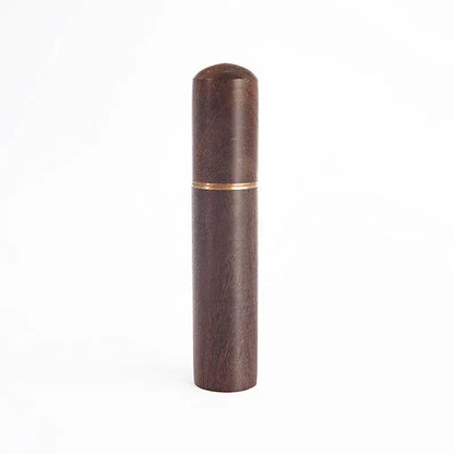Modern dark wood espresso coffee stirrer with subtle grain texture and gold band serving as a kitchen needle distributor
