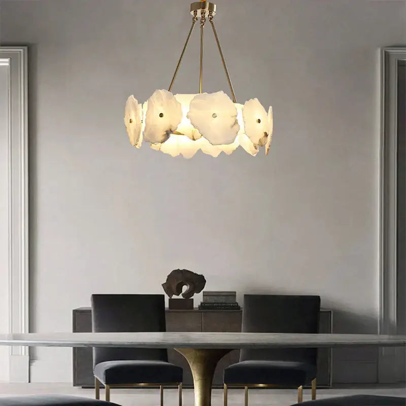 A modern decorbites brass marble ceiling chandelier with five off-white petal-shaped glass shades for dining rooms