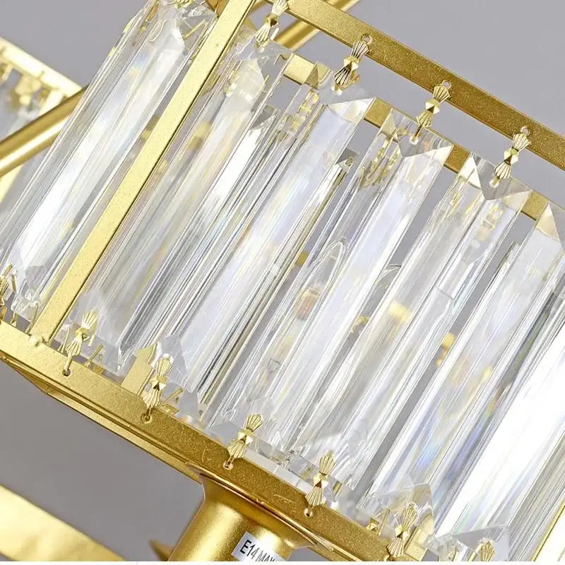 A modern decorbites copper crystal chandelier with gold-finished metal frame and clear crystal prisms for dining room