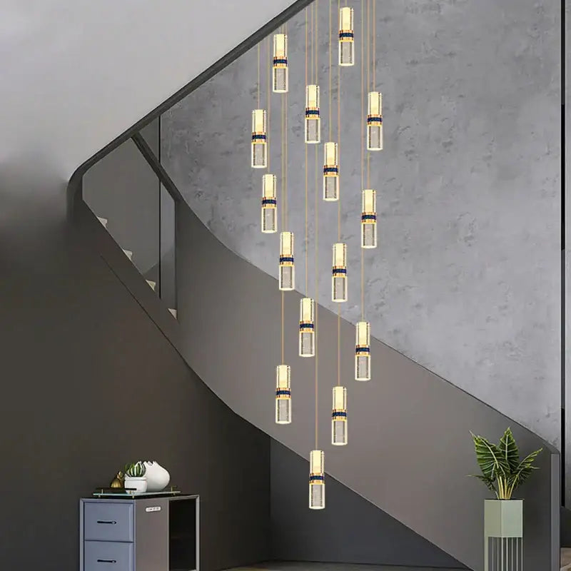 Modern decorbites crystal columnar chandelier with clear glass cylinders and gold-toned metallic accents for stairway light