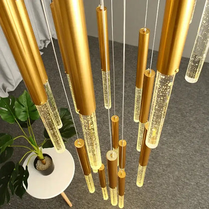 Golden cylindrical pendant lights with glowing bubbles in clear glass rods from decorbites crystal gold chandelier