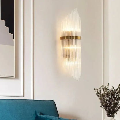 Gold-toned decorbites crystal gold led wall sconce with vertical glass rods emitting warm glow for modern bedroom light