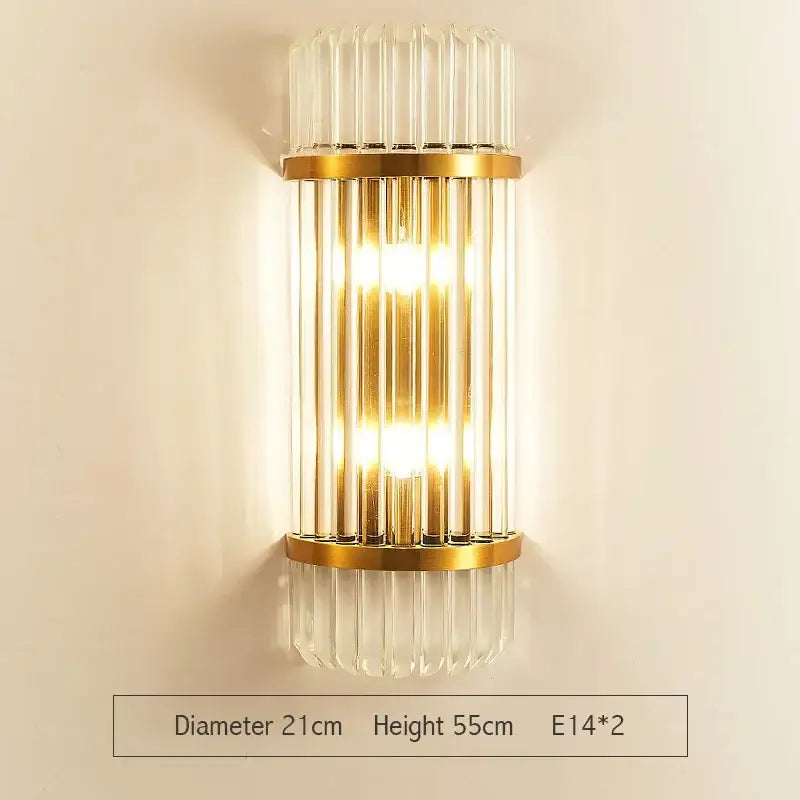 Gold-toned decorbites crystal gold led wall sconce with vertical crystal rods and warm glowing light for bedroom decor