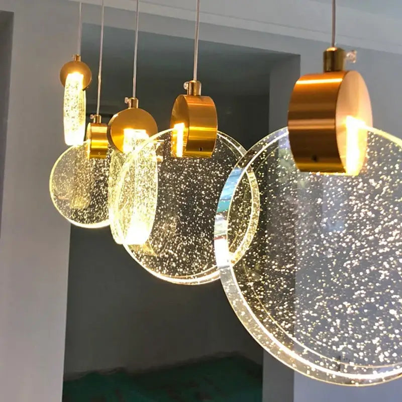 Modern gold-toned decorbites crystal led chandelier with clear bubble-filled glass discs for living room pendant lighting