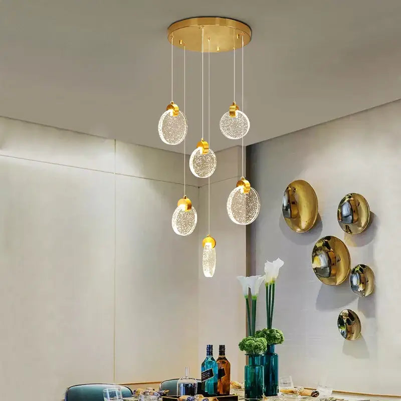 Gold-toned decorbites crystal led chandelier with five clear textured glass orbs for modern living room decor