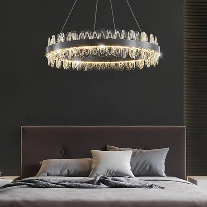 A modern decorbites crystal led chandelier with a black metal frame and cascading clear crystal droplets for living rooms