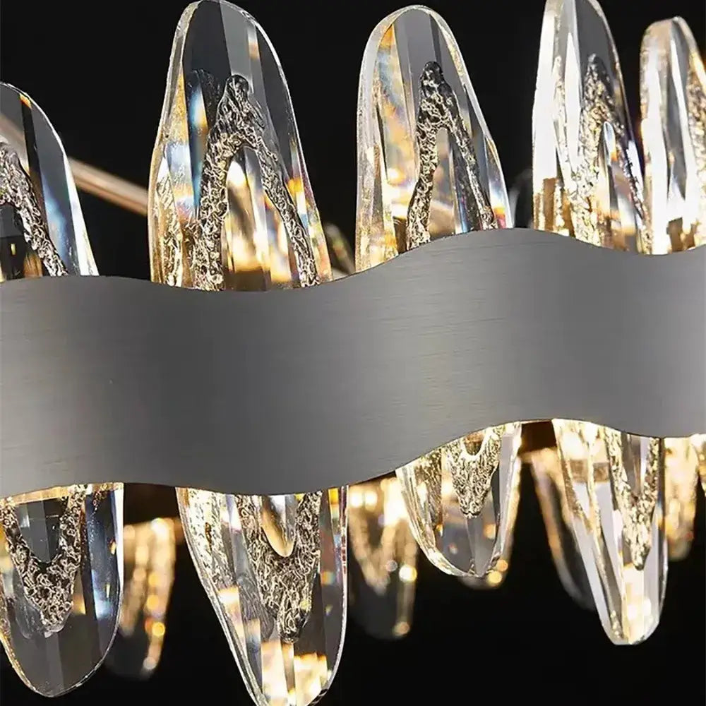 Modern decorbites crystal led chandelier with clear faceted crystal droplets and gold-leaf details on silver frame
