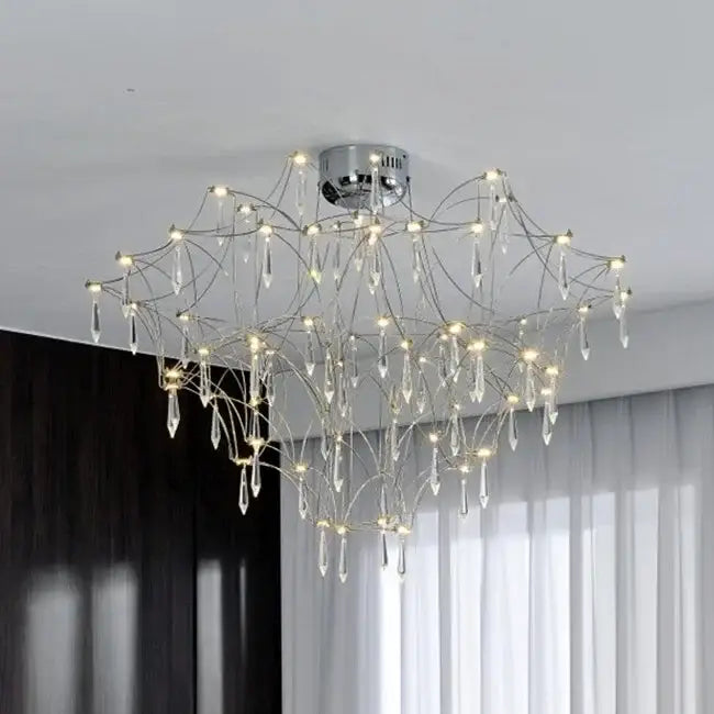 A modern chrome chandelier with intricate branching arms and dangling crystal droplets decorbites deluxe crystal star lamp