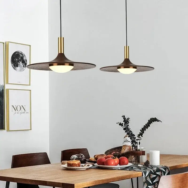 Two modern pendant lights with brass stems and dark bronze saucer solid wood shades from decorbites flying saucer chandelier