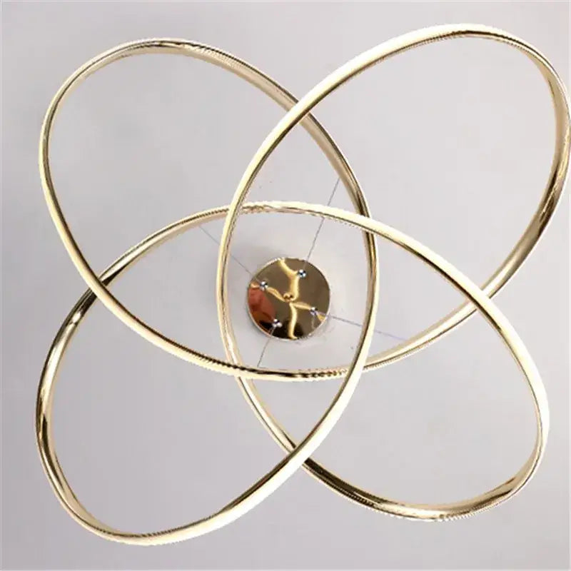 Modern decorbites gold ring led chandelier with gold-toned atomic model and intersecting circular rings for dining room lighting