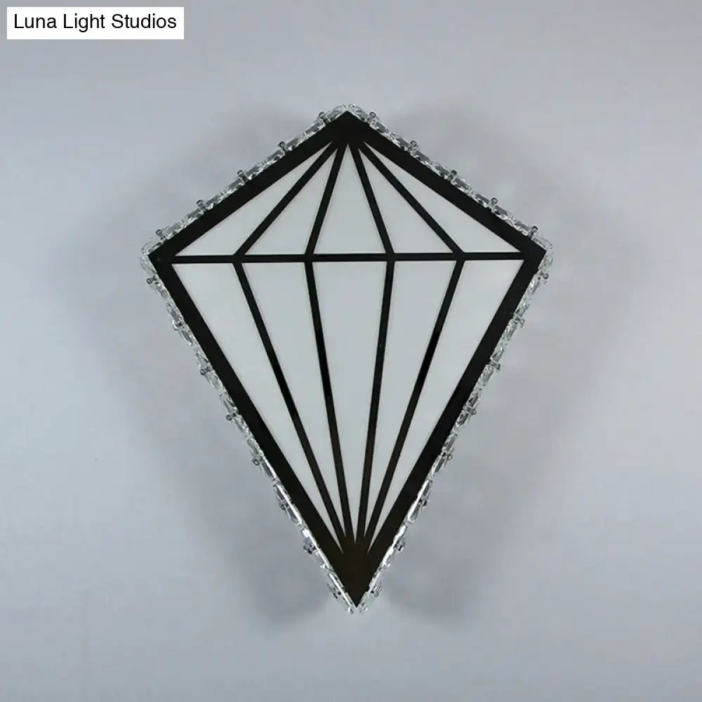 Modern diamond white wall light with black and white geometric design framed by crystal accents and warm white light bulb base