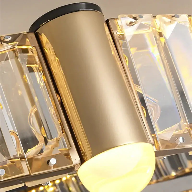 Modern double ring gold-toned crystal ceiling chandelier with clear crystal accents and warm yellow bulbs by decorbites crystal ceiling