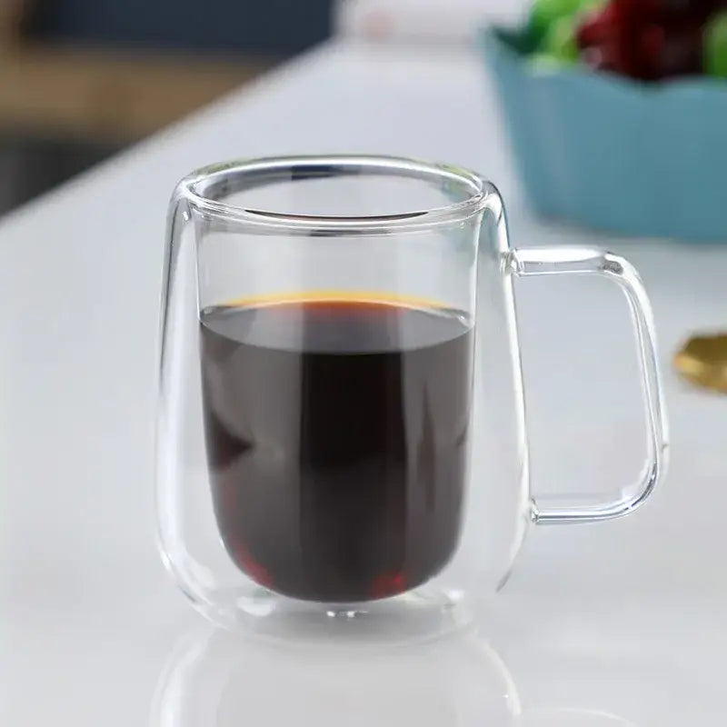 Modern double walled glass coffee mug filled with dark coffee featuring a clear decorbites glass coffee design
