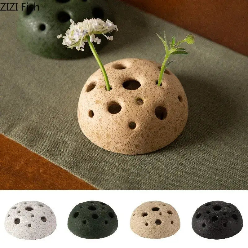 Beige modern earthy lotus seedpod ceramic vase with textured porous surface and multiple circular holes for decor