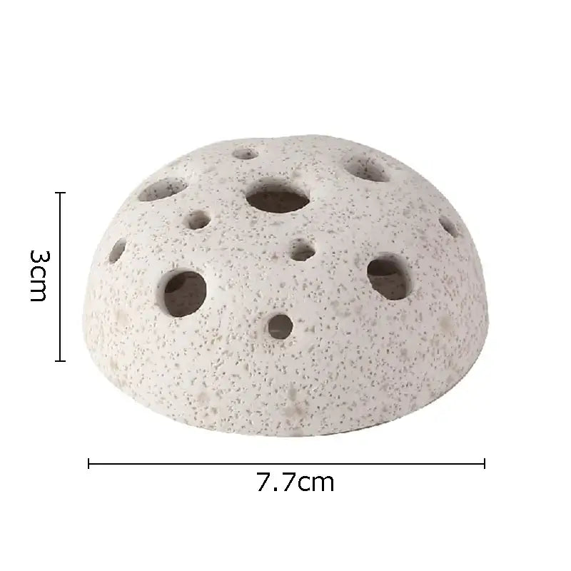 A light gray porous lotus seedpod ceramic incense burner with multiple circular holes for modern living room decor