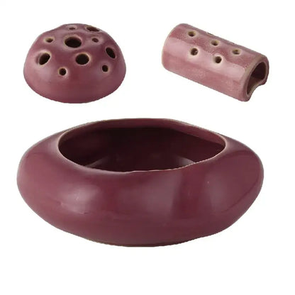Maroon lotus seedpod ceramic incense burner set with rounded base, perforated lid, and cylindrical component for decor